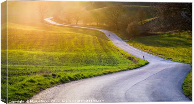 Road in a tuscan landscape at sunset  Canvas Print by Marco Bicci