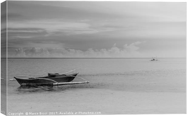 A filipino boat with a fisherman at the horizon Canvas Print by Marco Bicci