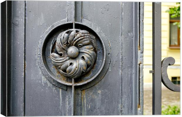 Old metal gate with wrought iron flower Canvas Print by Yury Petrov