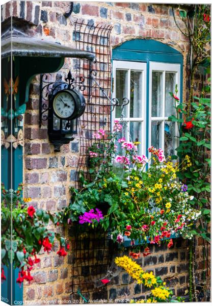 Flowers and a clock outside an English country cottage  Canvas Print by Kevin Hellon