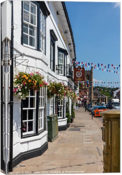 Hanging baskets outside the Catherine Wheel pub  Canvas Print by Kevin Hellon
