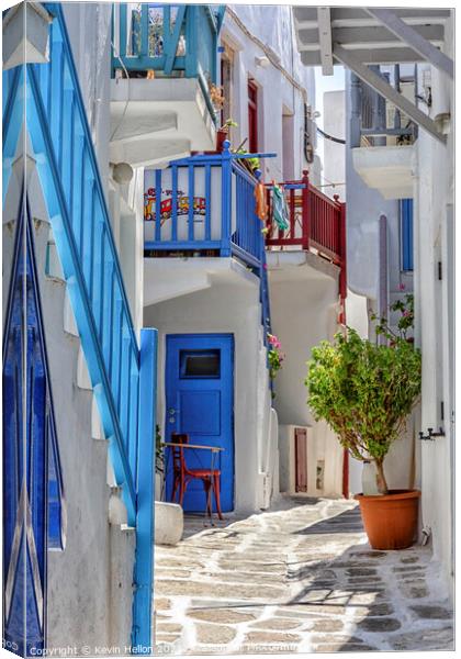Typical street on the island of Mykonos, Greece Canvas Print by Kevin Hellon
