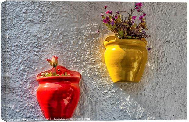 Colourful plantpots with flowers hanging on a wall, Canvas Print by Kevin Hellon