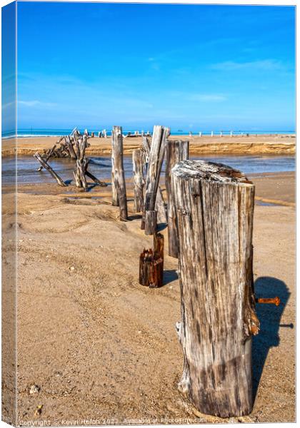 Posts in the sand Canvas Print by Kevin Hellon