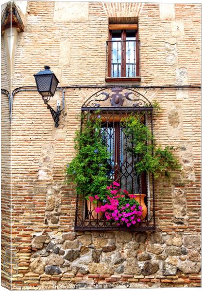 Window with flowers in old house in Toledo, Spain Canvas Print by Kevin Hellon