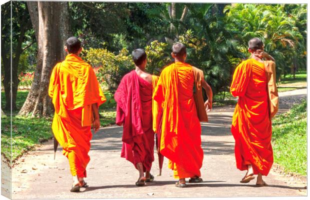 Monks in orange and maroon robes Canvas Print by Kevin Hellon