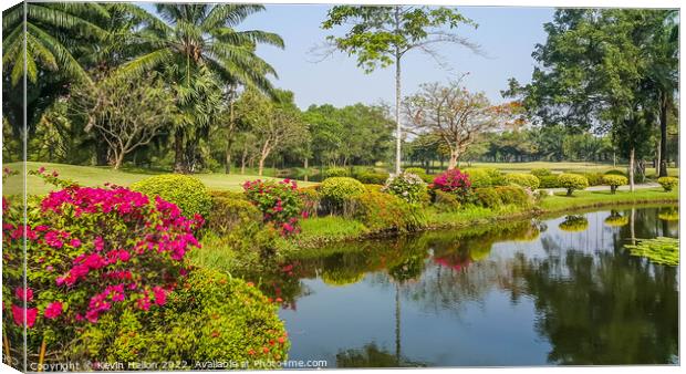 Lake and flowers, Dynasty golf course, Nakhon Pathom, Thailand Canvas Print by Kevin Hellon