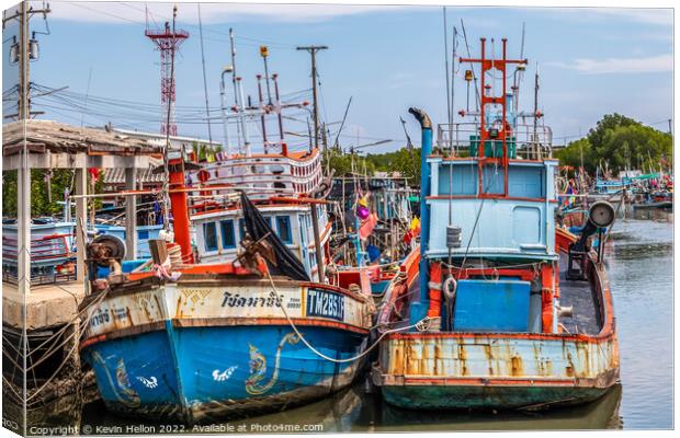 Thai fishing boats in harbour Canvas Print by Kevin Hellon