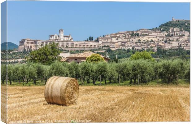 Hay roll overlooked by the Basilica di San Francesco D'Assisi, U Canvas Print by Kevin Hellon