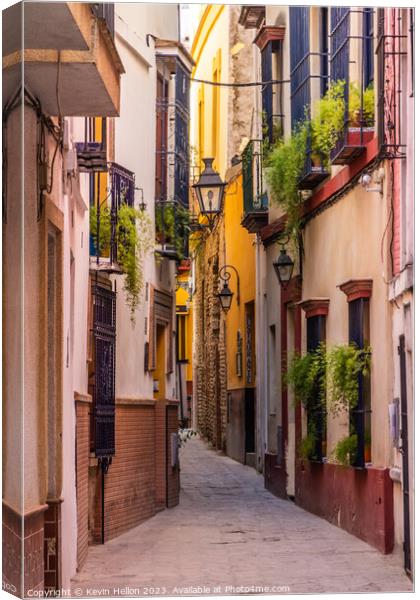 Narrow street in Seville, Spain Canvas Print by Kevin Hellon