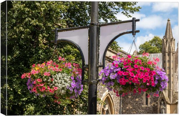Hanging baskets outside St Marys Church, High Wycombe Canvas Print by Kevin Hellon