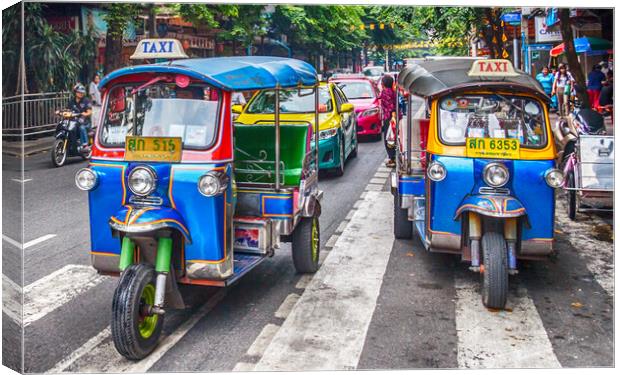 Tuk tuks on a street in the city. Canvas Print by Kevin Hellon