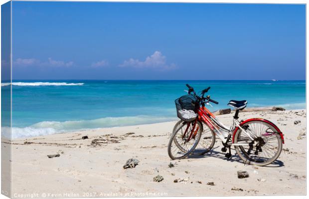 Bicycles on a white sand beach Canvas Print by Kevin Hellon