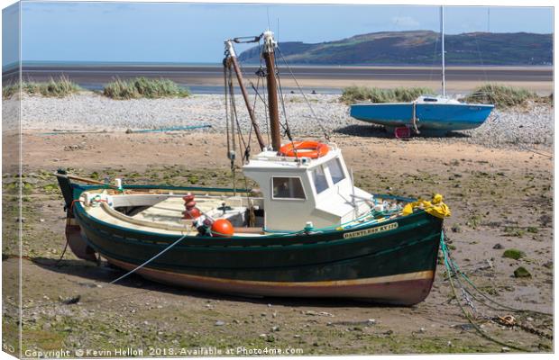 Boats moored in Red Wharf BayAnglesey at low tide. Canvas Print by Kevin Hellon