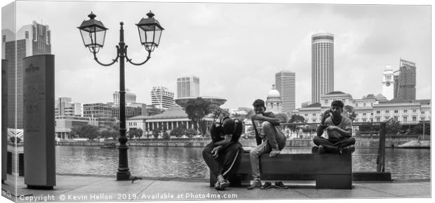 Three men sat on a bench on Boat Quay, Singapore  Canvas Print by Kevin Hellon