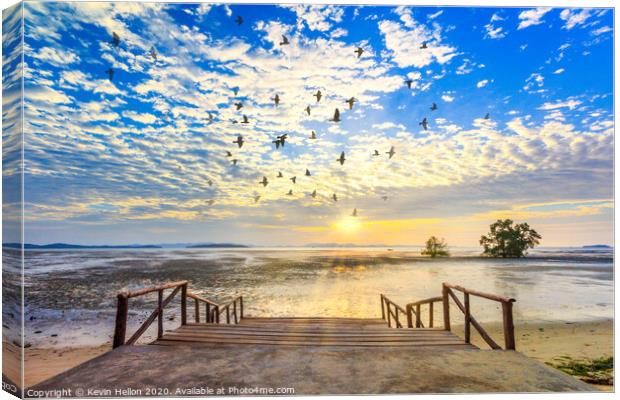 Sunrise with sunrays and flock of birds Canvas Print by Kevin Hellon