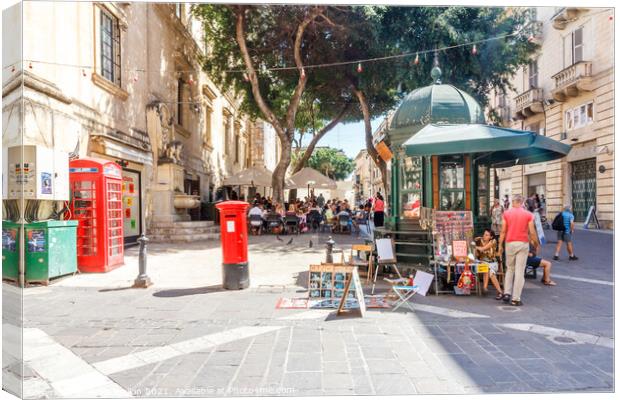 Square with cafe and kiosk.  Canvas Print by Kevin Hellon