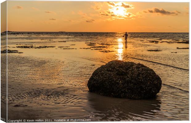 Rock and fisherman silhouette  Canvas Print by Kevin Hellon