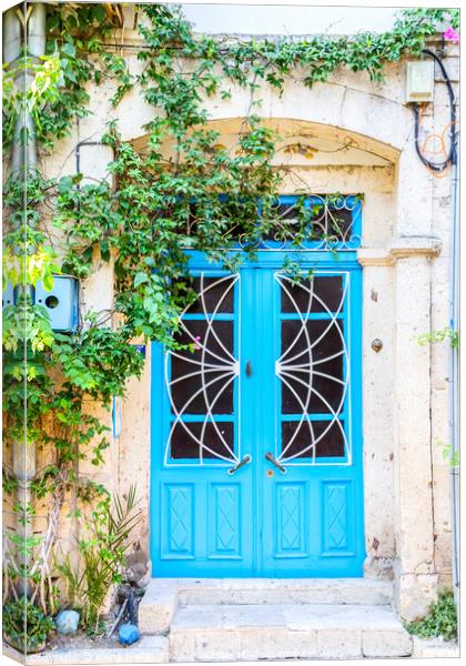 Blue door on house Canvas Print by Kevin Hellon