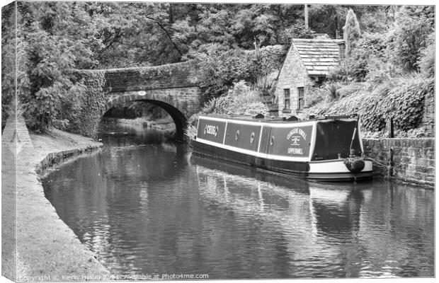 Barge moored next to a bridge Canvas Print by Kevin Hellon