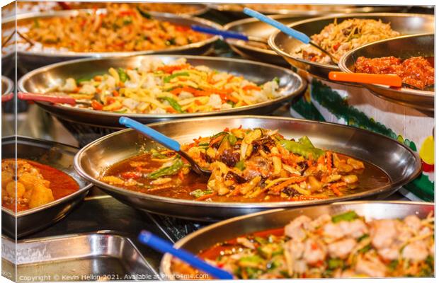 Platters of Thai food on a street food stall Canvas Print by Kevin Hellon