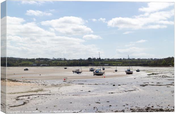 Boats moored in Red Wharf Bay Anglesey at low tide Canvas Print by Kevin Hellon