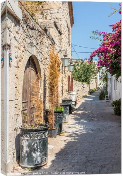 Narrow street with stone houses Canvas Print by Kevin Hellon