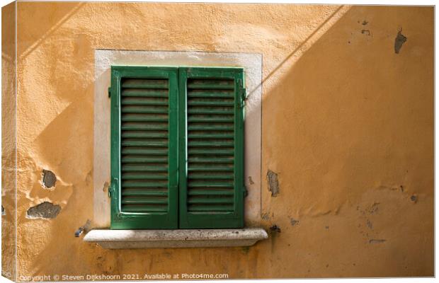 Green shutters and a yellow concrete wall in Italy Canvas Print by Steven Dijkshoorn