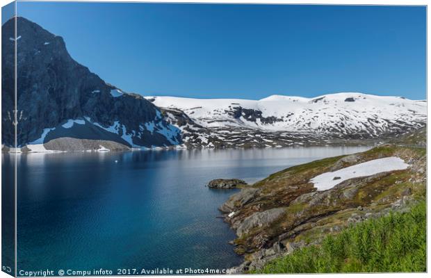 fjord with snow in summer in norway Canvas Print by Chris Willemsen
