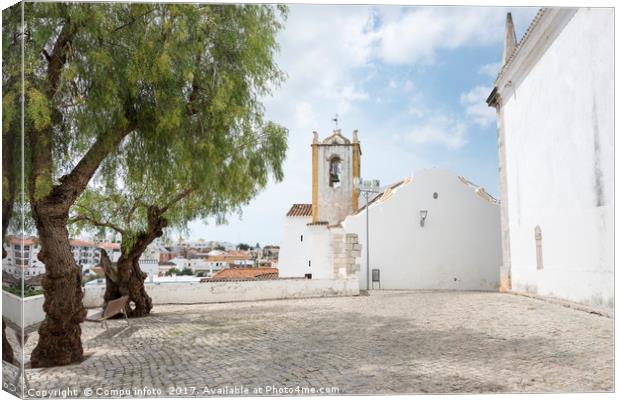 olive trees and church in tavira Canvas Print by Chris Willemsen