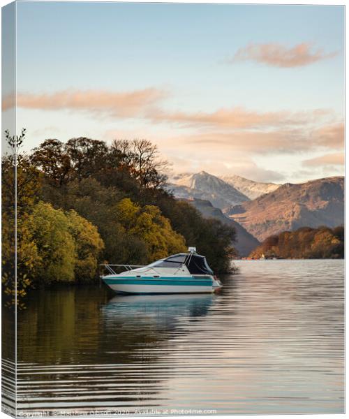 Landscape image of boat moored on Ullswater in Lake District with snowcapped mountains in background with beautiful vibrant Autumn Fall colors Canvas Print by Matthew Gibson