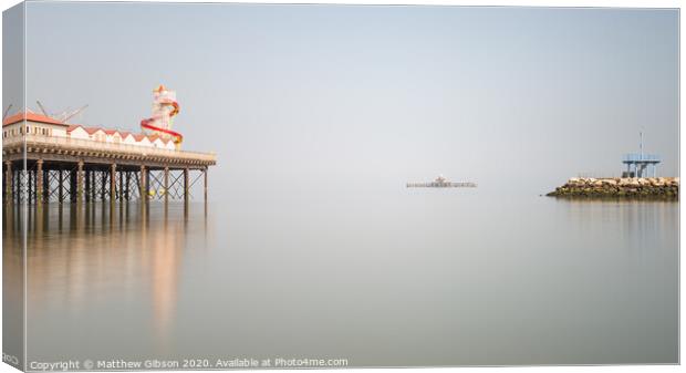 Minimalist fine art landscape image of colorful pier in juxtaposition with old derelict pier in background Canvas Print by Matthew Gibson