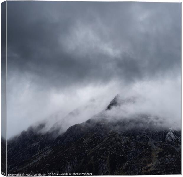 Stunning detail landscape images of snowcapped Pen Yr Ole Wen mountain in Snowdonia during dramatic moody Winter storm Canvas Print by Matthew Gibson