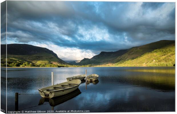 Landscape image of rowing boats on Llyn Nantlle in Snowdonia at sunset Canvas Print by Matthew Gibson
