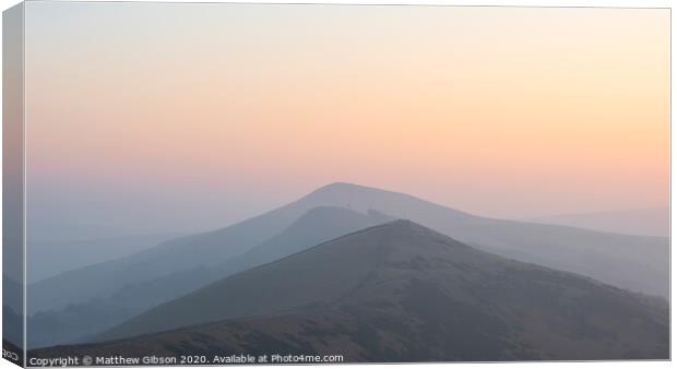 Stunning Winter sunrise landscape image of The Great Ridge in the Peak District in England with a cloud inversion and mist in the Hope Valley with a lovely orange glow Canvas Print by Matthew Gibson