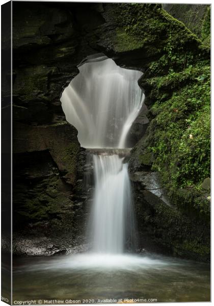 Beautiful flowing waterfall with magical fairytale feel in lush green forest location Canvas Print by Matthew Gibson