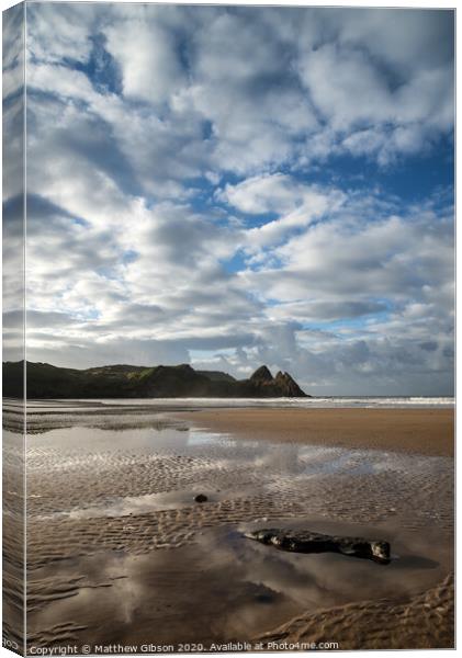 Beautiful blue sky morning landscape over sandy Three Cliffs Bay Canvas Print by Matthew Gibson