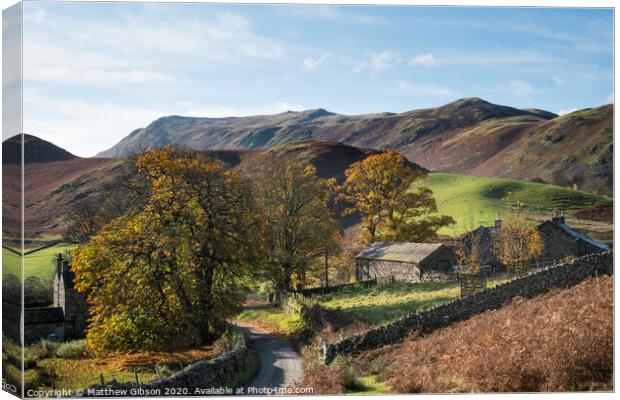 Old derelict farm buildings in Autumn Fall landscape image in Lake District with Sleet Fell in background with epic light on the fells Canvas Print by Matthew Gibson