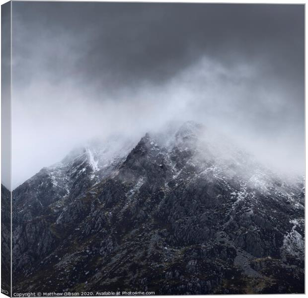 Stunning detail landscape images of snowcapped Pen Yr Ole Wen mountain in Snowdonia during dramatic moody Winter storm Canvas Print by Matthew Gibson