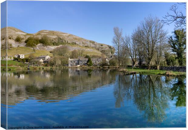 Kilnsey Trout Farm Lake with Kilnsey Crag in the background. Canvas Print by Chris North