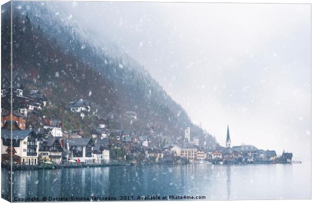 Austrian mountain town under snowfall Canvas Print by Daniela Simona Temneanu