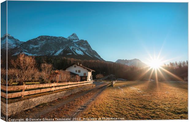 Winter sunshine over Austrian Alps and village Canvas Print by Daniela Simona Temneanu