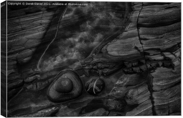 Rocks on the beach at Sandymouth (mono) Canvas Print by Derek Daniel