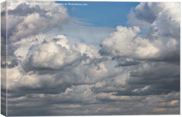 Cumulus clouds are gradually covering the blue sky. Canvas Print by Sergii Petruk
