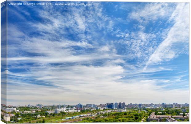Panorama of the city under a high beautiful blue sky with light white curly clouds. Canvas Print by Sergii Petruk