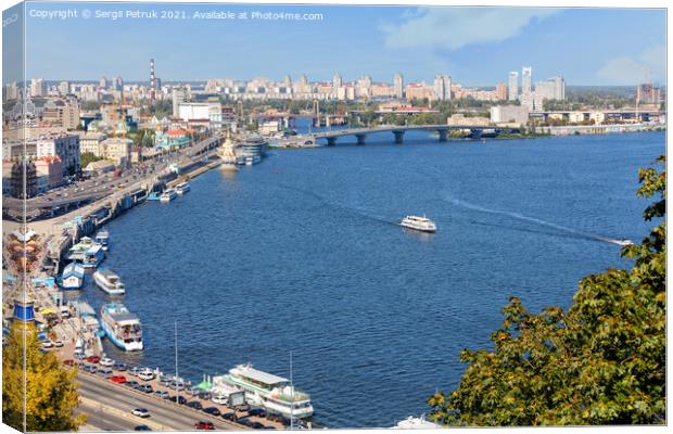 A landscape of summer Kyiv with a view of the Dnipro embankment in the old Podil district, a river station, piers, river trams and pleasure boats.30.08.20, Kyiv, Ukraine. Canvas Print by Sergii Petruk