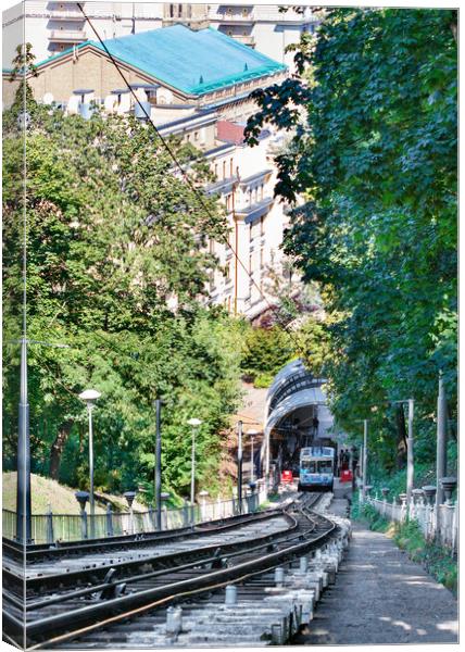 Funicular rail track, the car is filled with passengers at the lower station, surrounded by a summer green park. Canvas Print by Sergii Petruk