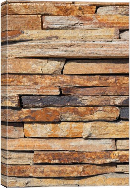 Brown slabs of old sandstone are lined with a wall. Canvas Print by Sergii Petruk