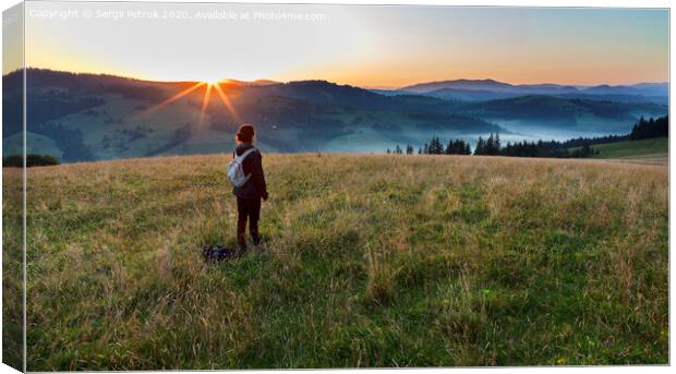 A young woman meets a dawn on a meadow hill in the Carpathian Mountains Canvas Print by Sergii Petruk