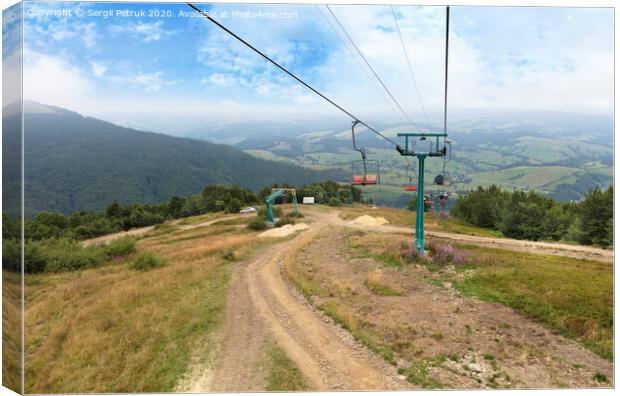 The mountain lift carries tourists and luggage up and down the mountains Canvas Print by Sergii Petruk